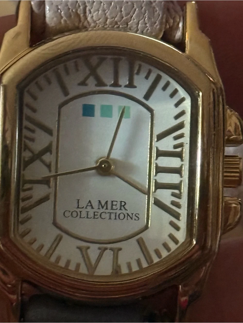 LA Mer Collections gold chain and leather wrap bracelet watch
